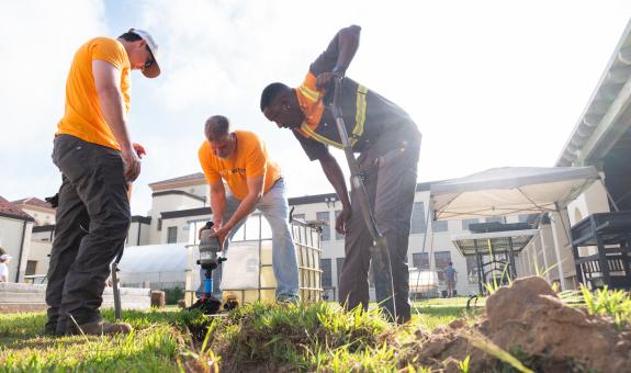 spire volunteers shoveling in a garden